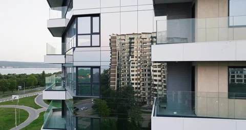 Modern skyscraper sharp angles glass walls capturing urban reflections aerial Stock Footage 301875232