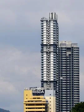 Modern Skyscraper Tower With RISDA Sign And Urban Architecture Against Blue Sky Stock Photos
