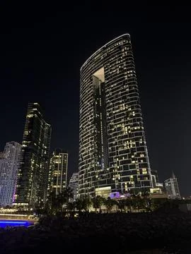 Modern Skyscraper with Unique Design at Night Stock Photos