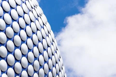 Modern sleek architecture building texture background with blue cloudy sky Stock Photos