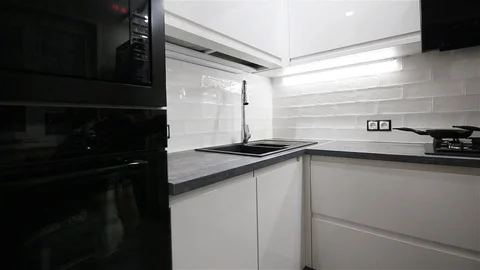 Modern small kitchen interior in white and black colors. Stock Footage 97746376