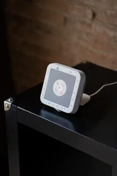 Modern smart home security keypad on a dark table with touchscreen interface Stock Photos
