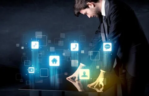 Modern smart table with high tech icons on its interface screen Stock Photos