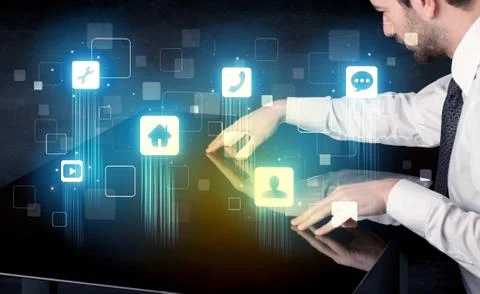 Modern smart table with high tech icons on its interface screen Stock Photos