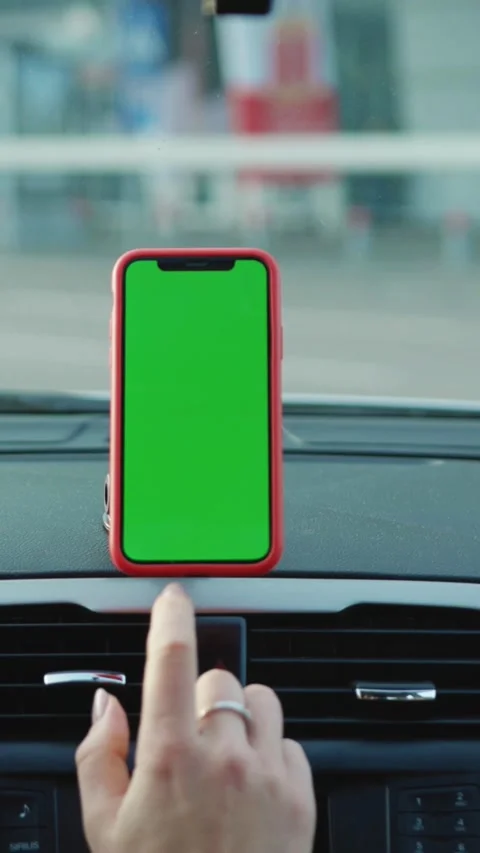 A modern smartphone featuring a green screen displayed prominently on a cars Stock Footage 314170560