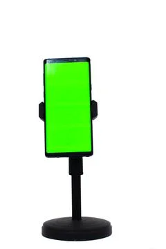 Modern smartphone with green screen atop a sleek stand for creative technol.. Stock Photos