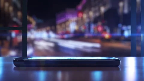 Modern smartphone lighting up on table with city view at night in background Stock-Footage 302396748