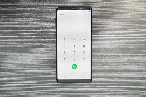 Modern Smartphone With Numeric Keypad Displayed Showing Incoming Call And G.. Stock Photos