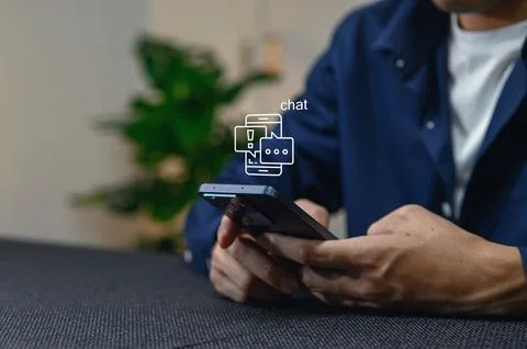 Modern Smartphone User Engaging in Digital Chat Interaction Stock Photos