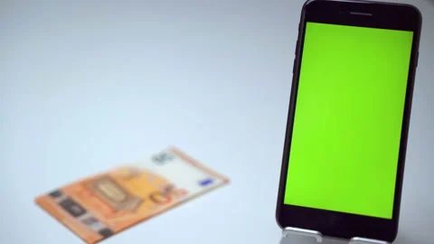 Modern smartphone with vertical green screen on foreground, and person's hand 스톡 동영상 132060052