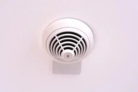 Modern smoke sensor installed on ceiling Stock-Fotos