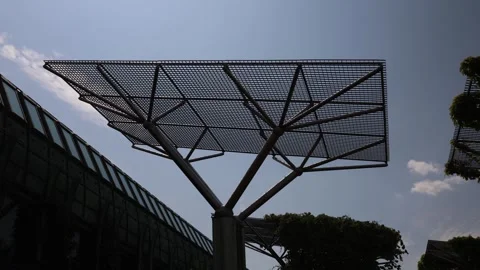 Modern solar heating structure with geometric metal frame stands under clear sky Stock Footage 312677509