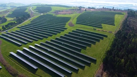 Modern Solar Panel Array sprawling across a lush green hilltop. Stock Footage 332626968