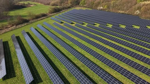 Modern solar panel Farm on grass field in rural landscape of America. Sunny day Stock Footage 332596844
