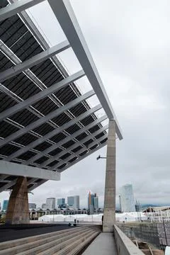 Modern solar panel structure overlooking Barcelona skyline on a cloudy day Stock Photos