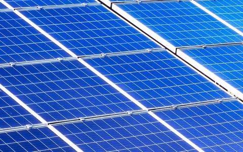 Modern solar panels generate clean sustainable energy on a bright day Stock Photos