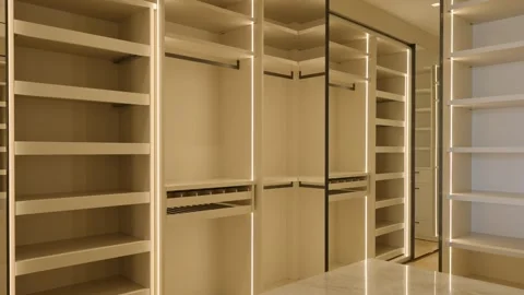 Modern spacious walk-in wardrobe with multiple shelves and hanging rods Stock Footage 293850520