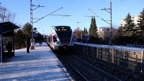 Modern speed train arrives at Kilo station. Passengers enter the train. Stock Footage 130139552