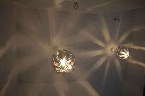 Modern spherical pendant lights casting light patterns on the ceiling Stock Photos