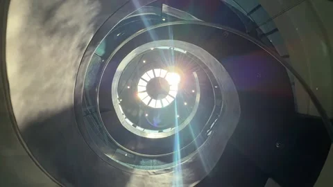Modern Spiral Staircase Bottom View and Sunlight Flare from window on the roof Vídeos de archivo 343476552