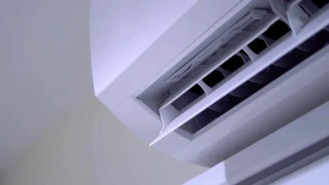 Modern split air conditioner unit starting up and swinging louvers Stock-Footage 333485125
