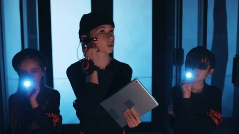 Modern spy kids sneaking in database, waling inside dark server room inspecting Stock Footage 120697695