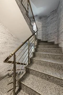 Modern stair case between floors. Stairs with metallic rail  in modern buildi Stock-Fotos