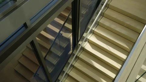 Modern staircase with beige steps and glass railings. Comfortable staircase Stock Footage 293850385