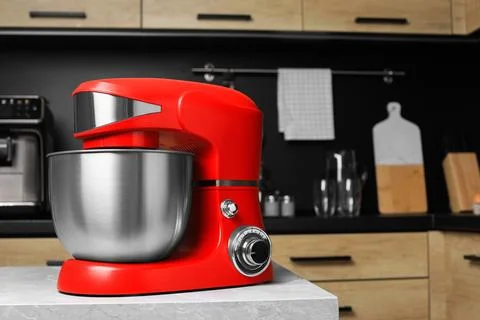 Modern stand mixer on table in kitchen, space for text. Home appliance Stock Photos