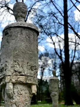 Modern statue against the background of trees and clouds Stock Photos