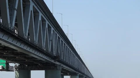 Modern steel bridge structure extending across river Stock Footage 330707921