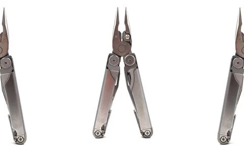 Modern steel multitool with many tools isolated on white background. Portab.. Foto stock