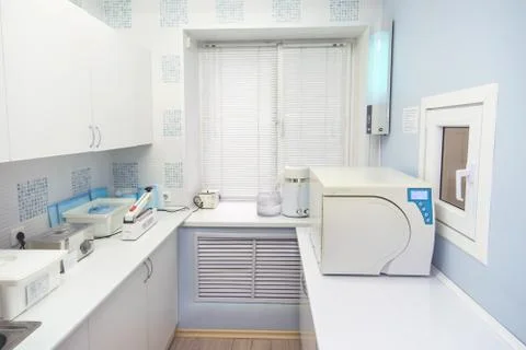 Modern sterilization room interrior, handling of dental instruments workplace. Stock Photos