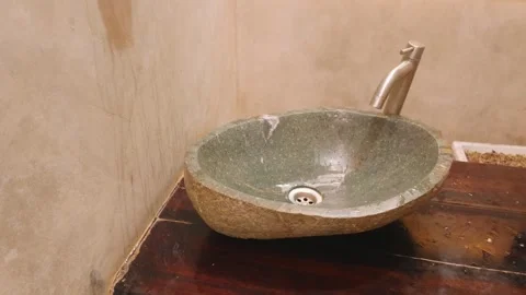 Modern stone basin washbasin in a rustic style bathroom interior. 库存影片 343376165