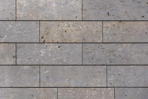 Modern stone facade texture of smooth natural stone plates at modern building Stock Photos