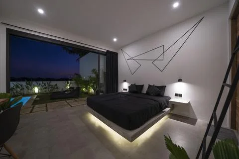 Modern stone pine bed with red led lighting, wall lamps. Bedroom in luxury .. Stock Photos