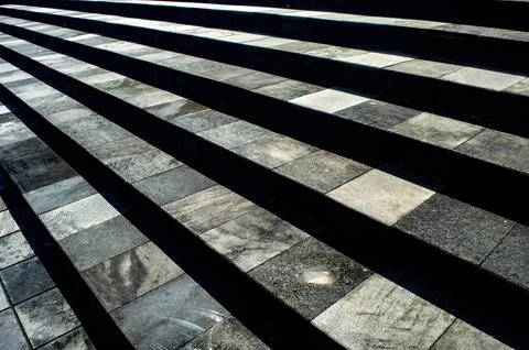 Modern stone steps with a checkered pattern of light and dark tiles, creati.. Stock Photos