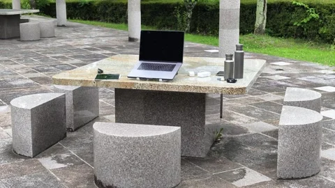 Modern stone table with laptop outdoors Stock Footage 340240720