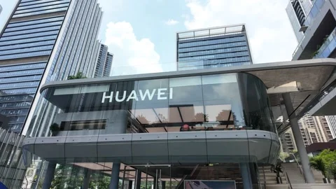 A modern storefront with a glass facade and a curved roof, featuring the "huawei Stock Footage 287001155