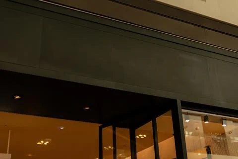 A modern storefront shows a blank space where a logo can be placed. The facad Stock-Fotos