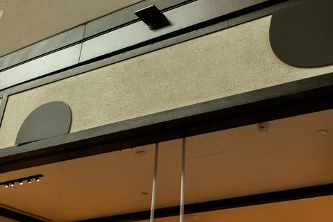 A modern storefront shows an empty area for a logo and signage. The shop has  Stock Photos
