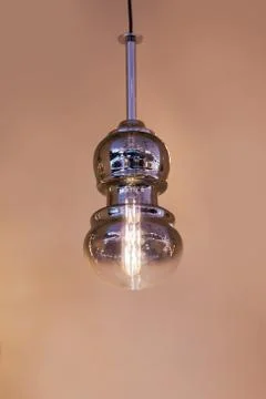 Modern streamlined mirror copper silver chandelier. Bubble metal glass shade  Stock Photos