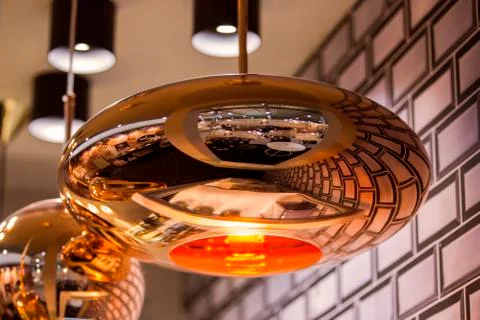 Modern streamlined mirror oval copper chandelier. Bubble metal copper shade p Stock Photos