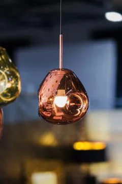 Modern streamlined mirror oval copper chandelier. Bubble metal copper gold sh Stock Photos