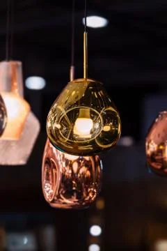 Modern streamlined mirror oval copper chandelier. Bubble metal copper gold sh Stock Photos