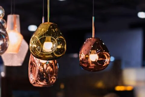 Modern streamlined mirror oval copper chandelier. Bubble metal copper gold sh Stock Photos