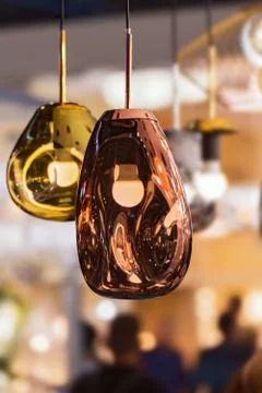 Modern streamlined mirror oval copper chandelier. Bubble metal copper gold sh Stock Photos