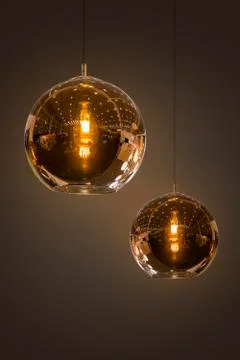 Modern streamlined mirror round copper chandelier. Bubble glass transparent p Stock Photos
