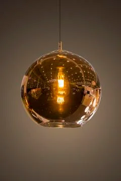 Modern streamlined mirror round copper chandelier. Bubble glass transparent p Stock Photos