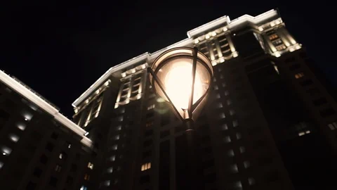 Modern street lamp on the background of a multi-storey building, night lighting Stock Footage 130066000